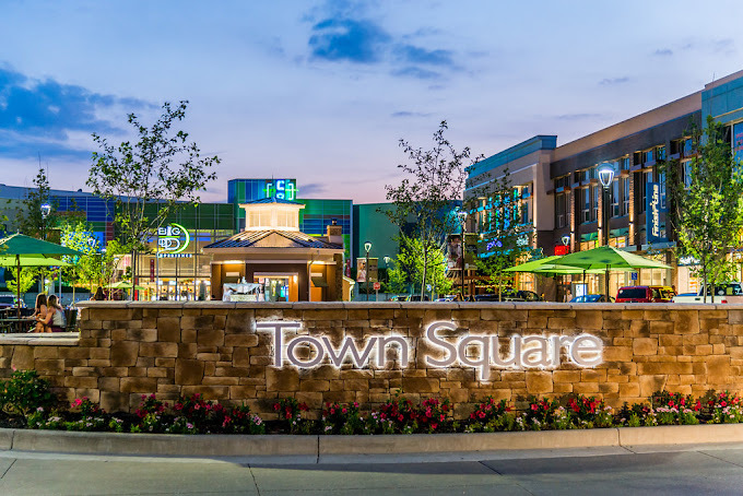 Exterior view with a brick entrance sign with glowing letters "Town Square."