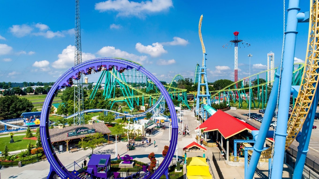 A view of a large amusement park with a view of many large roller coasters and rides.