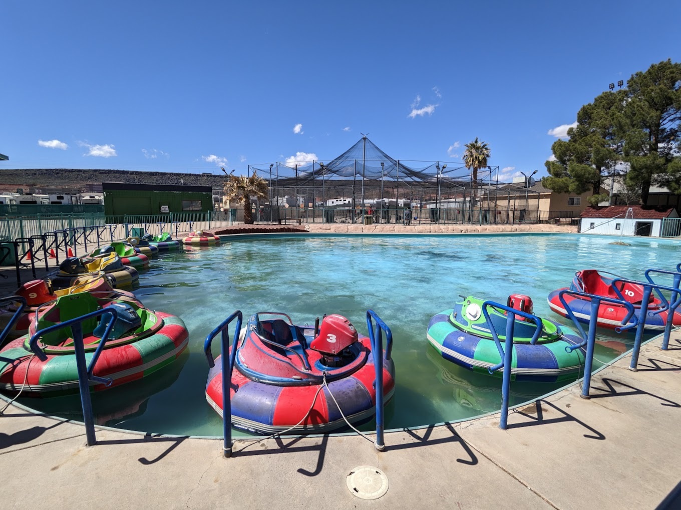 A small pool with colorful controllable innertubes lined around the outside.