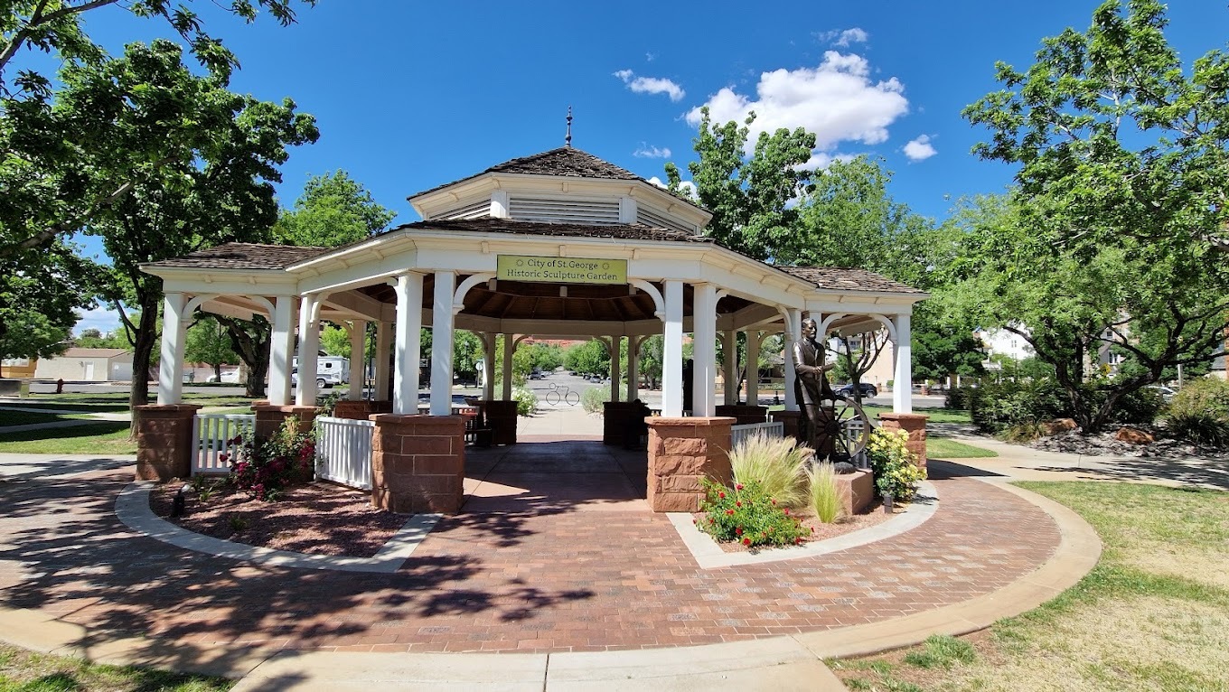 A blue sunny day in the background, with a white gazebo structure in the foreground.