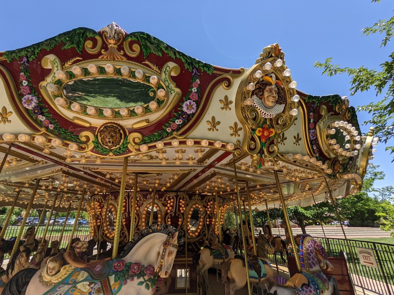 Blue sky background with a colorful lighting carousel in the foreground.