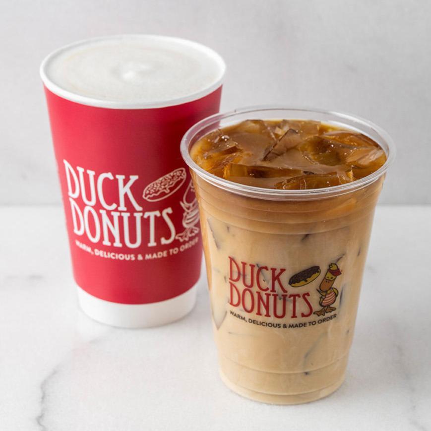 A photo of two coffees, an iced coffee and a hot coffee.
