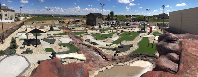 An bird's eye view of the whole mini-golf course, displaying the many golfing holes and water features.