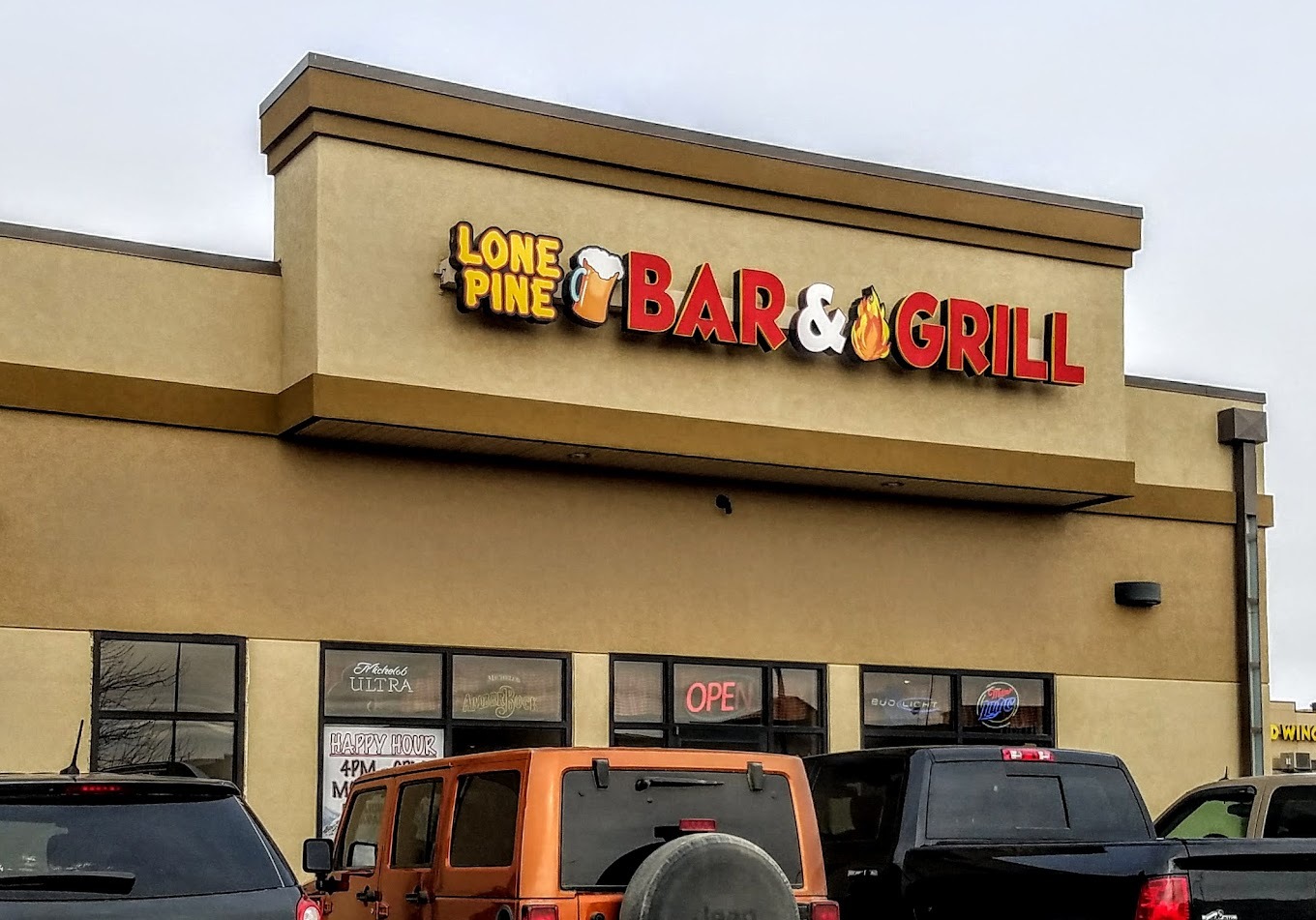 A beige building with a sign reading "Lone Pine Bar & Grill" on the top.
