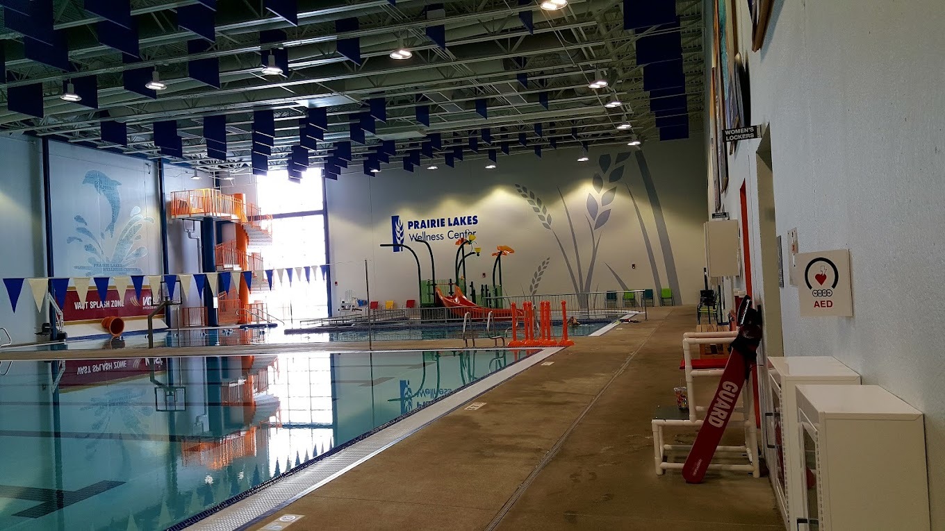 Landscape view of a large indoor diving pool, complete with in-pool basketball hoops.